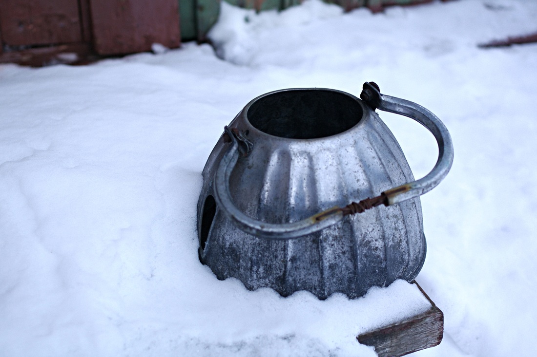 Metal tea pot in the snow